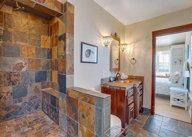 bathroom with vanity and a shower