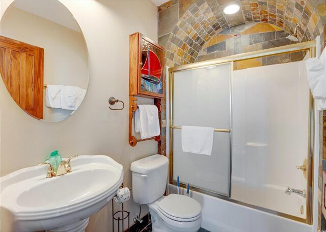 full bathroom featuring toilet, sink, shower / tub combo, and tile patterned floors