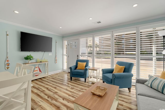 living room featuring light hardwood / wood-style floors and crown molding