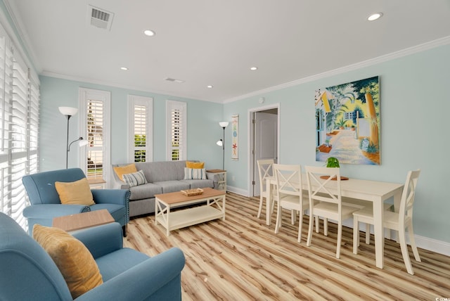 living room with light hardwood / wood-style flooring and crown molding