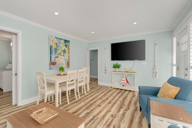 living room featuring a wealth of natural light, light hardwood / wood-style floors, and crown molding