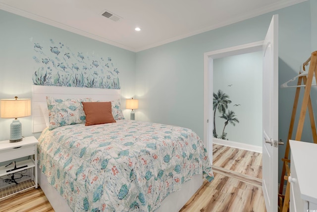 bedroom featuring light hardwood / wood-style flooring and crown molding