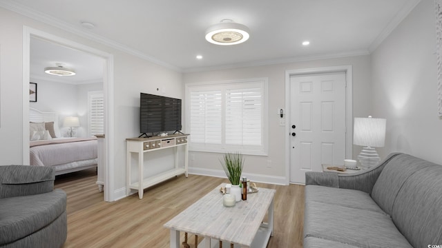 living room with light wood-type flooring and crown molding