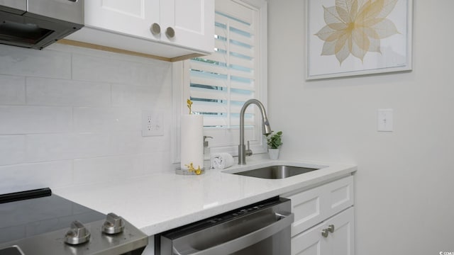 kitchen with stainless steel appliances, white cabinetry, and sink