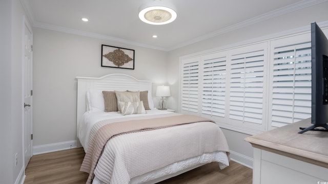 bedroom featuring wood-type flooring and crown molding