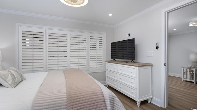 bedroom featuring crown molding and dark hardwood / wood-style flooring