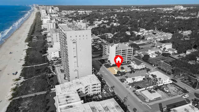 birds eye view of property featuring a beach view and a water view