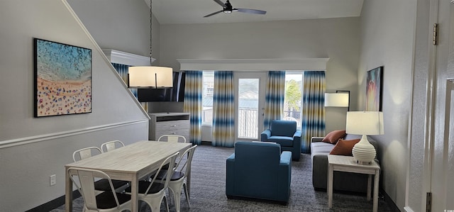 living room featuring ceiling fan and dark carpet