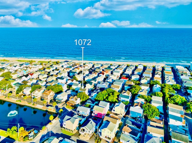 birds eye view of property featuring a beach view and a water view