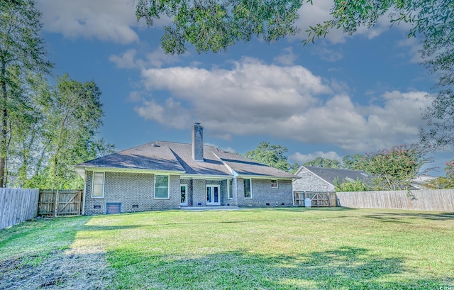 back of house with a lawn