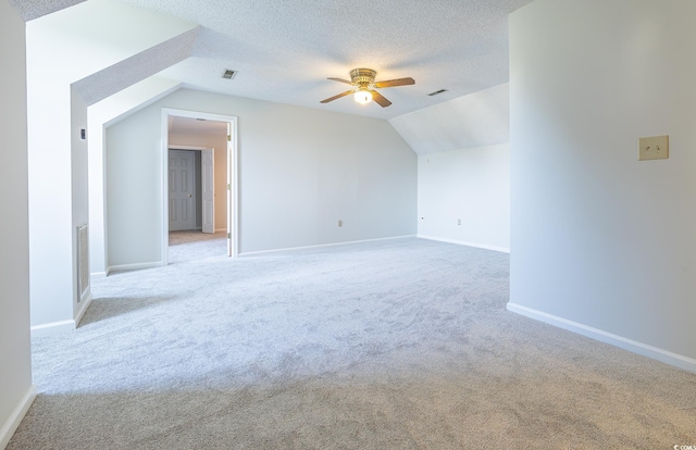 additional living space with ceiling fan, light carpet, and vaulted ceiling