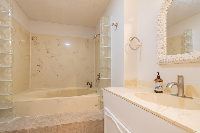 bathroom featuring vanity, a textured ceiling, and bathtub / shower combination