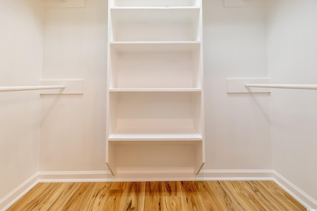 walk in closet with wood-type flooring