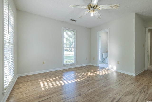 spare room featuring light wood-type flooring and ceiling fan