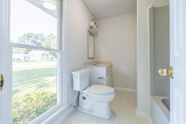 bathroom with toilet, vanity, and tile patterned floors