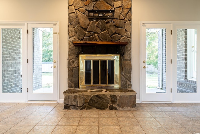 entryway with a fireplace and light tile patterned flooring