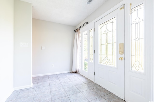 tiled foyer featuring plenty of natural light