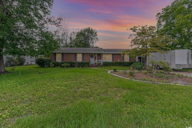 ranch-style house with a lawn