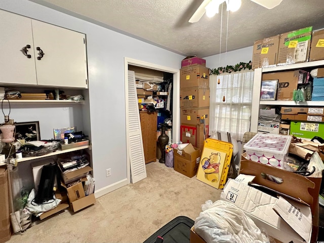 interior space featuring ceiling fan and a textured ceiling