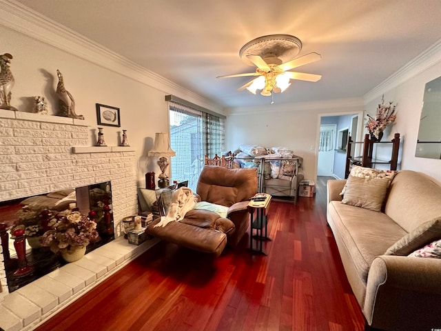 living room featuring ornamental molding, ceiling fan, dark hardwood / wood-style floors, and a fireplace