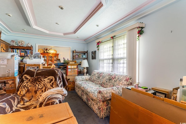 carpeted living room featuring a textured ceiling, crown molding, and a tray ceiling