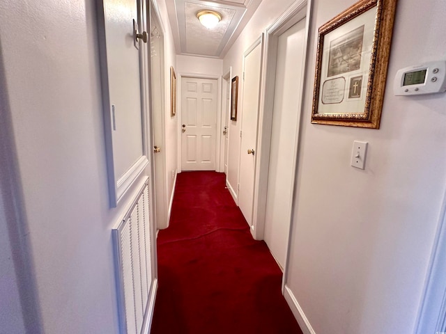 hall with carpet and a textured ceiling