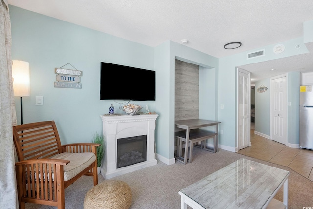 carpeted living room with a textured ceiling