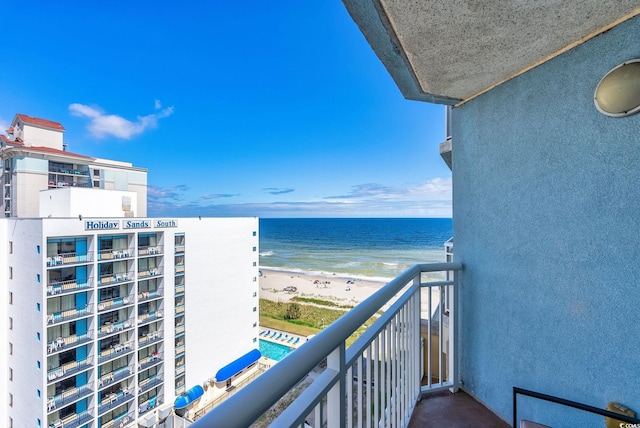 balcony featuring a beach view and a water view