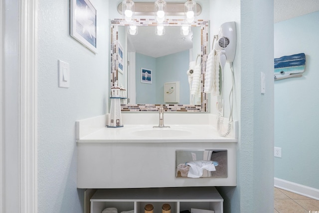 bathroom featuring tile patterned flooring, vanity, decorative backsplash, and a textured ceiling