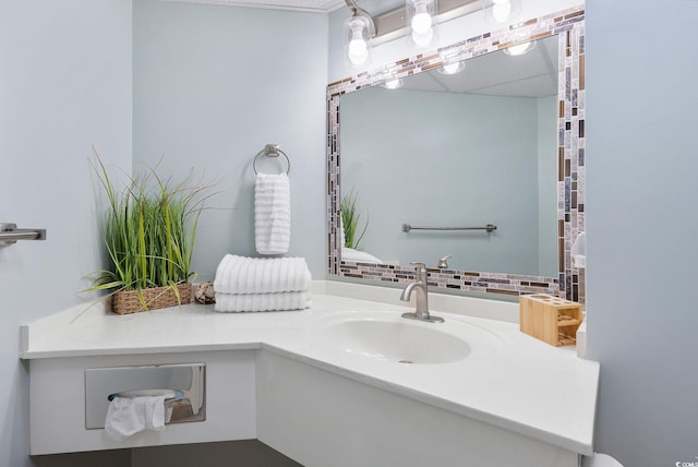 bathroom with vanity and tasteful backsplash