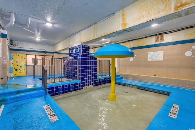 recreation room featuring concrete floors