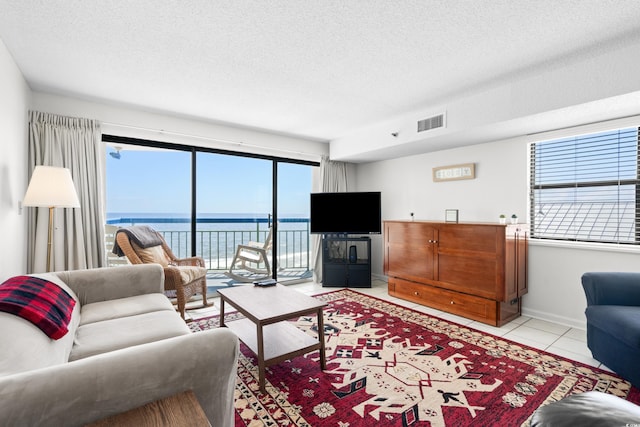 living room with light tile patterned floors and a textured ceiling