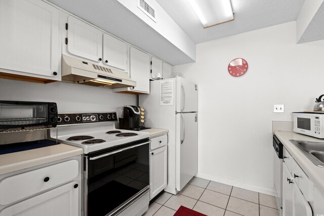 kitchen featuring white cabinets, light tile patterned floors, white appliances, sink, and a textured ceiling