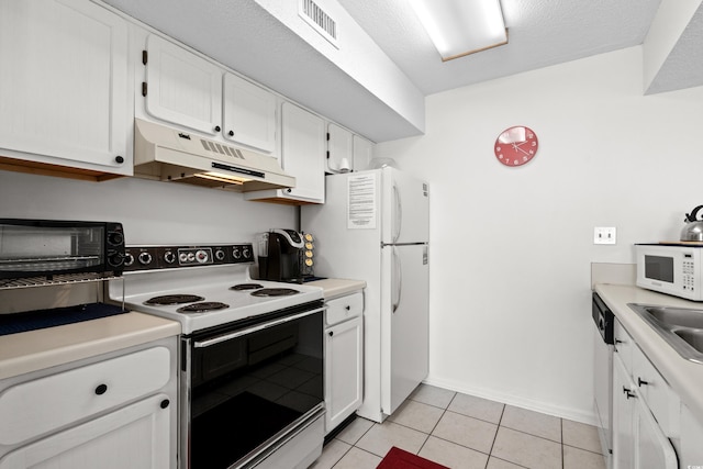 kitchen featuring white appliances, visible vents, white cabinets, under cabinet range hood, and light tile patterned flooring