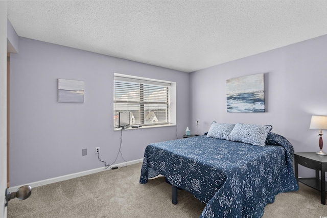 carpeted bedroom with a textured ceiling