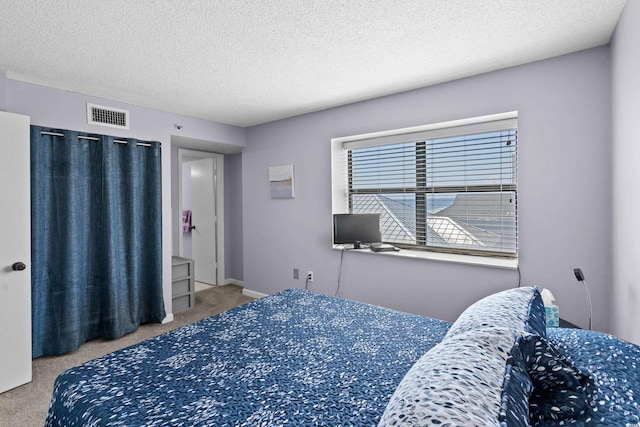 bedroom featuring baseboards, a textured ceiling, visible vents, and carpet flooring