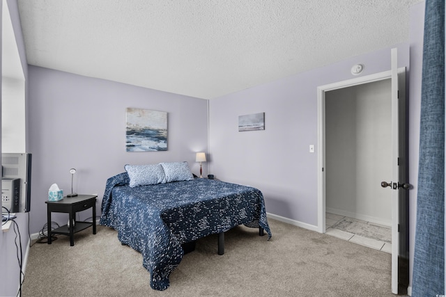 bedroom featuring a textured ceiling and light carpet