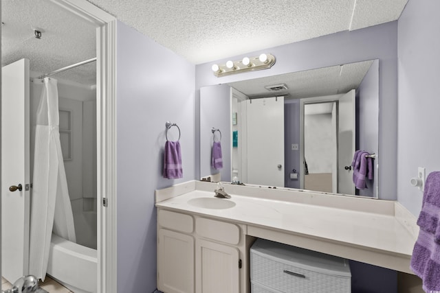 full bath with shower / bath combination with curtain, visible vents, a textured ceiling, and vanity