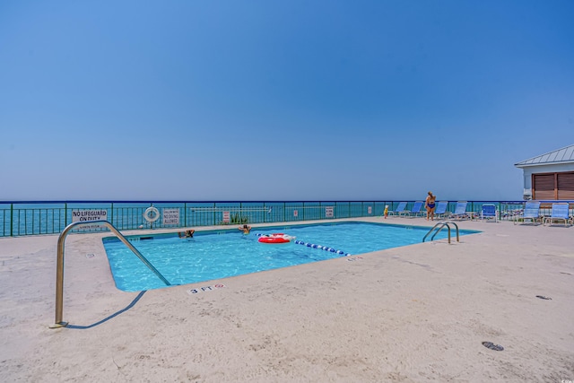 view of swimming pool with fence