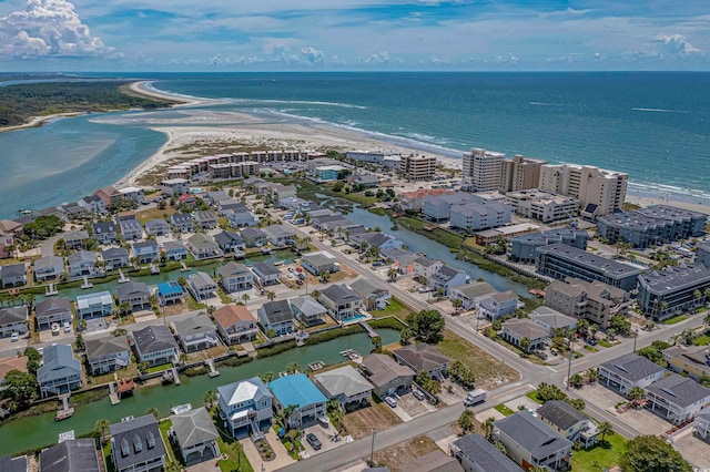 birds eye view of property featuring a beach view and a water view