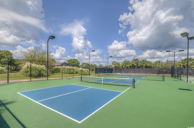 view of sport court featuring fence