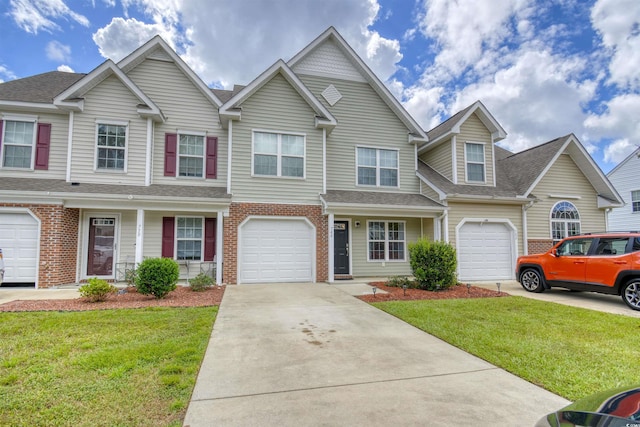 multi unit property with a garage and a front lawn