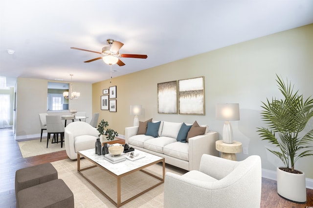 living room with ceiling fan with notable chandelier and wood-type flooring