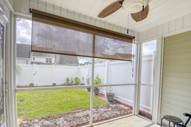 unfurnished sunroom featuring ceiling fan and wood ceiling