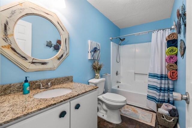 full bathroom featuring a textured ceiling, vanity, toilet, and shower / tub combo with curtain