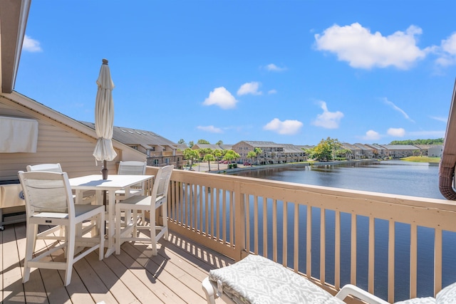 wooden terrace featuring a water view