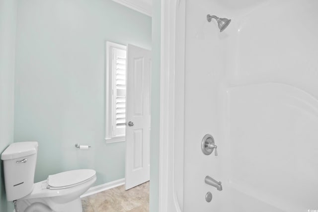 bathroom with bathtub / shower combination, toilet, and tile patterned flooring