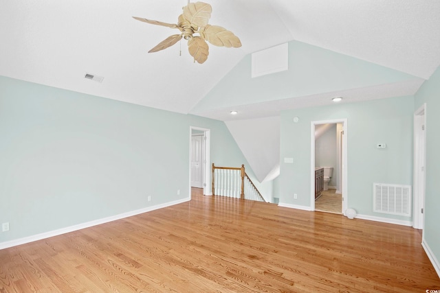 empty room with ceiling fan, light hardwood / wood-style flooring, and lofted ceiling