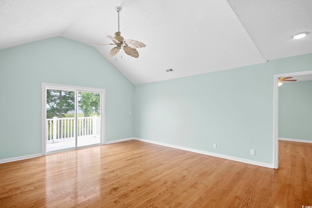 unfurnished room with light hardwood / wood-style flooring, vaulted ceiling, ceiling fan, and a textured ceiling