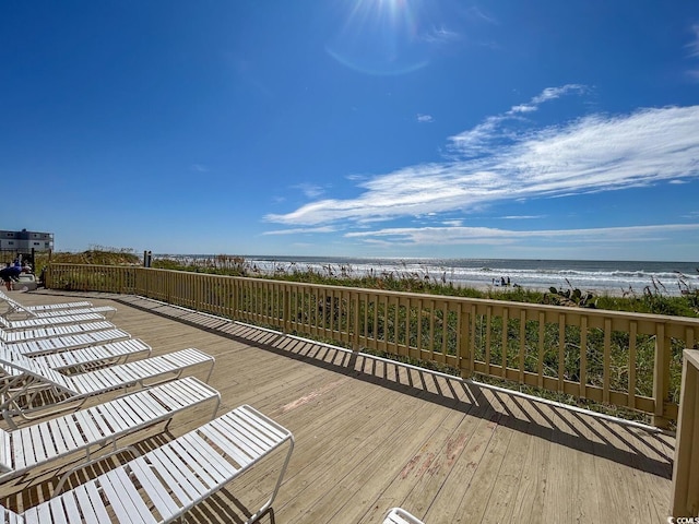 deck with a beach view and a water view